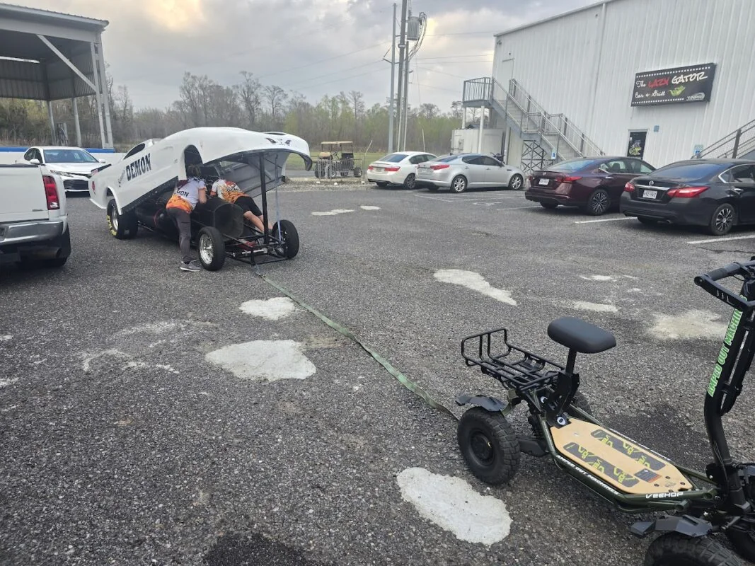 Behind the scenes of the Amped Out Machines electric mini ATV moving a race car